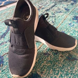 Nike Women’s black slip on sneakers with white accent size 9.